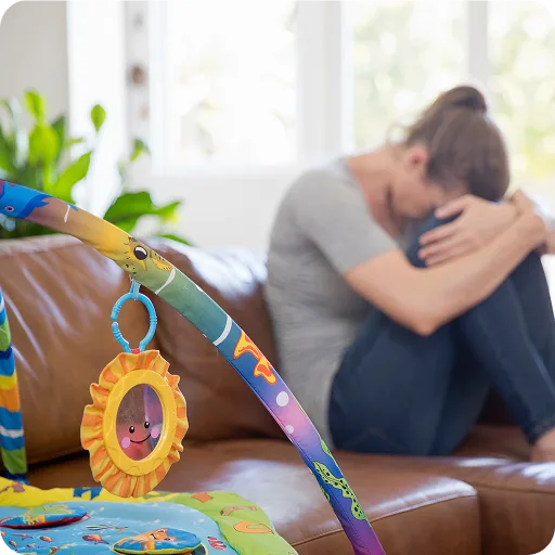Mother sitting with her head in her hands