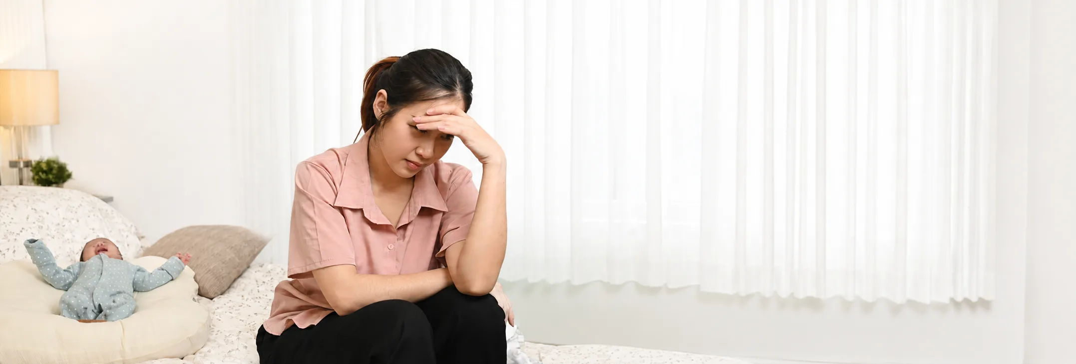 Tired mother sitting on a sofa