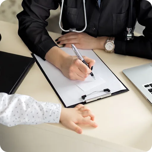 Doctor writing notes at a desk