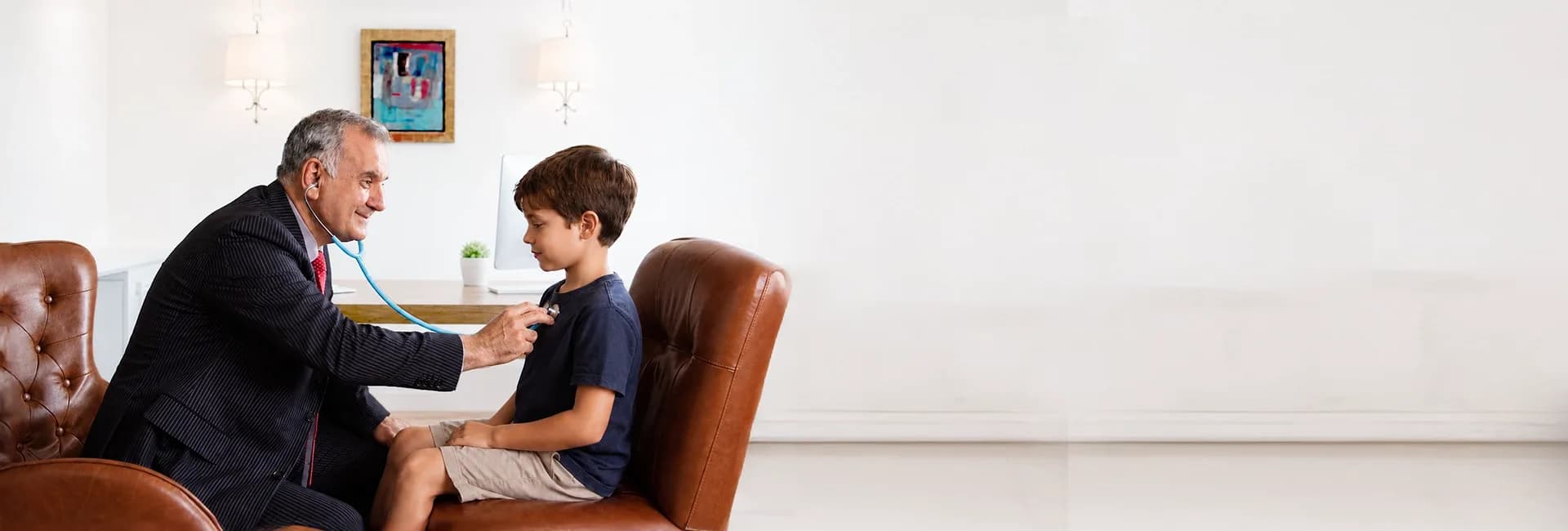 Paediatrician talking with a young boy