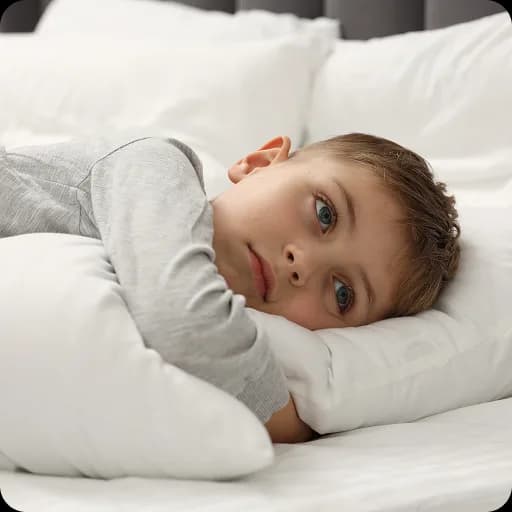 Boy lying awake in bed