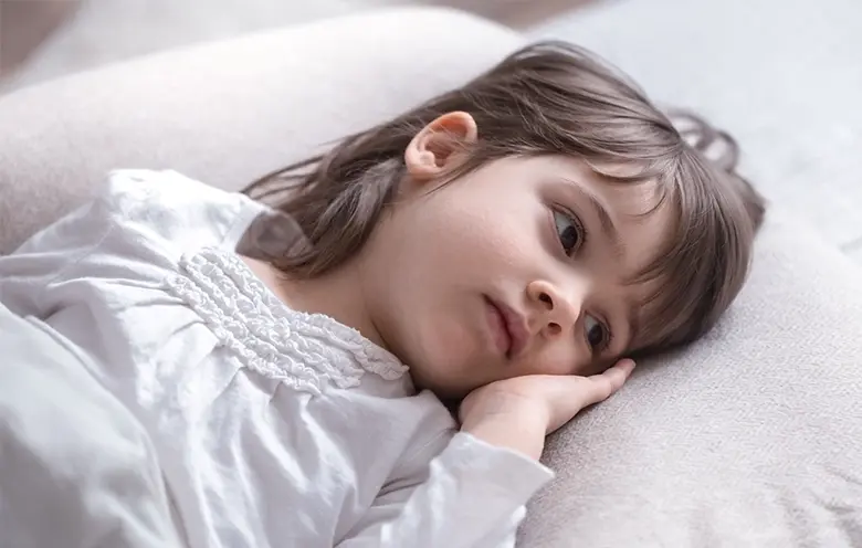 Girl lying awake in bed