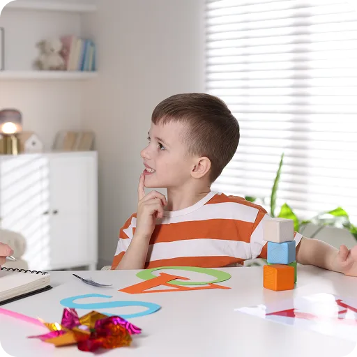Boy drawing at a table