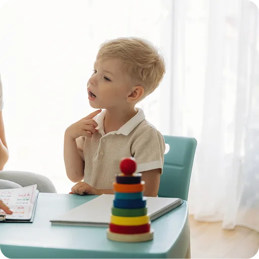 Toddler playing with stacking rings