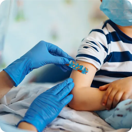 Gloved hand giving a child a vaccination